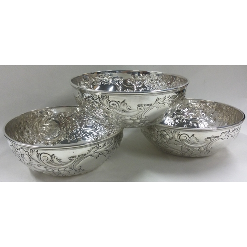 192 - A good set of three chased silver bowls embossed with flowers. Sheffield 1916. By James Dixon & Sons... 