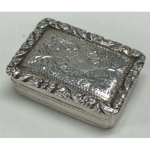 225 - A George III silver vinaigrette with engraved floral decoration. Birmingham 1825. By Thomas Newbolt.... 