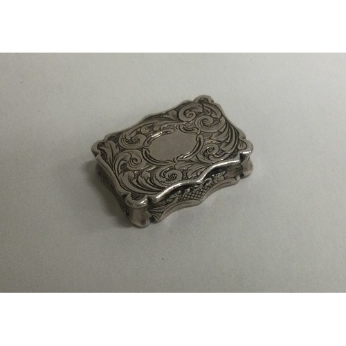 228 - NATHANIEL MILLS: A Victorian silver vinaigrette with engraved decoration. Birmingham 1848. Approx.10... 