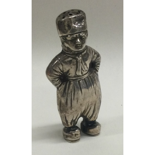 284 - A Chinese silver pepper in the form of a boy with hat. Makers marks HH to base. Approx. 28 grams. Es... 