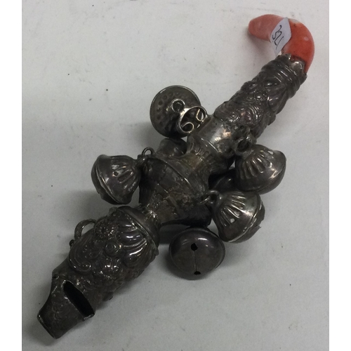 321 - An early 19th Century English silver rattle with coral handle. Approx. 60 grams. Est. £150 - £200.