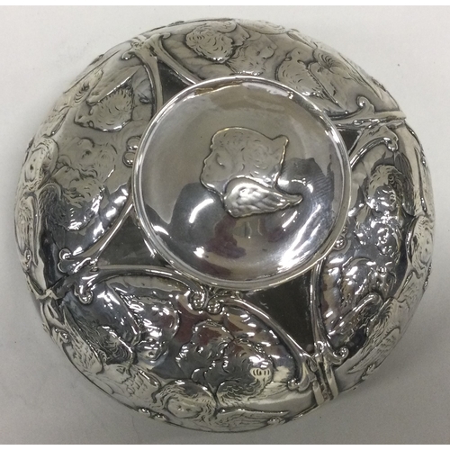 375 - A silver and glass inkwell embossed with cherubs. Birmingham 1904. By William Comyns. Est. £100 - £2... 