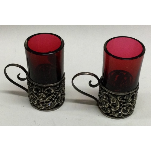 379 - A good pair of silver and cranberry glass spirit cups. Est. £30 - £40.