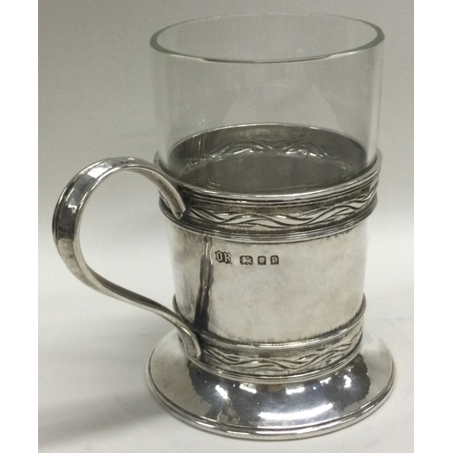 388 - OMAR RAMSDEN: A good silver mounted glass mug of typical design. London 1930. Approx. 168 grams of w... 