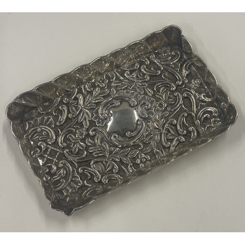 410 - A chased silver dish embossed with flowers. 1875. By Henry Matthews. Approx. 33 grams. Est. £30 - £5... 