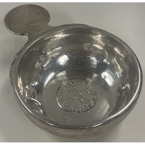 416 - A rare 18th Century French silver wine taster engraved with a man to handle. Approx. 115 grams. Est.... 