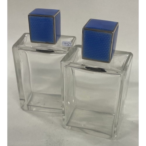 43 - A pair of silver and blue enamel scent bottles. c1930. Est. £100 - £200.