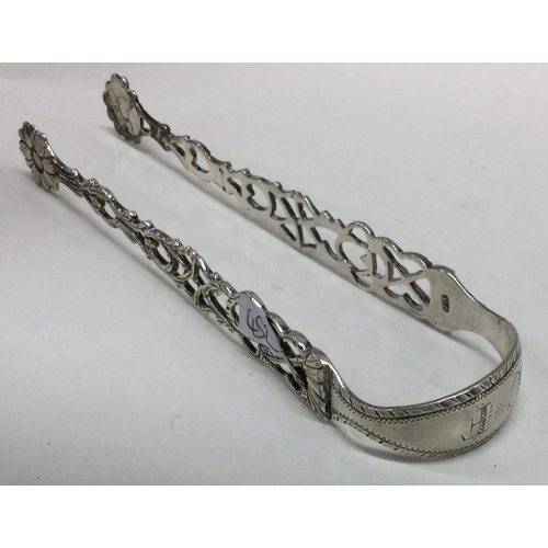 452 - A good pair of 18th Century silver sugar / ice tongs with pierced decoration. Makers mark only. Appr... 