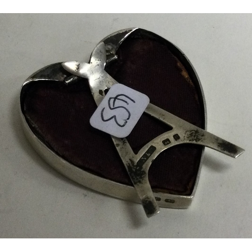 453 - A Victorian silver and red enamelled novelty photo frame in the form of a heart. Birmingham 1898. By... 