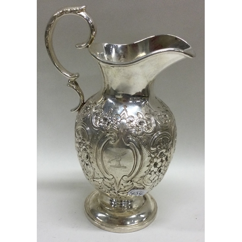 454 - EDINBURGH: A heavy chased Scottish silver milk jug with embossed decoration. 1882. Approx. 189 grams... 