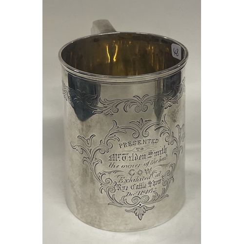 48 - A large Victorian silver engraved presentation pint mug. London 1872. By Henry Holland. Approx. 293 ... 