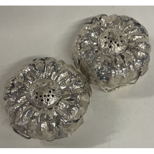 79 - A pair of unusual Japanese silver peppers in the form of pumpkins. Marked to base. Est. £40 - £60.