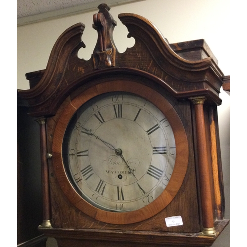 6 - An old oak grandfather clock with silver dial. By John Lee Wycombe. Est. £100 - £150.