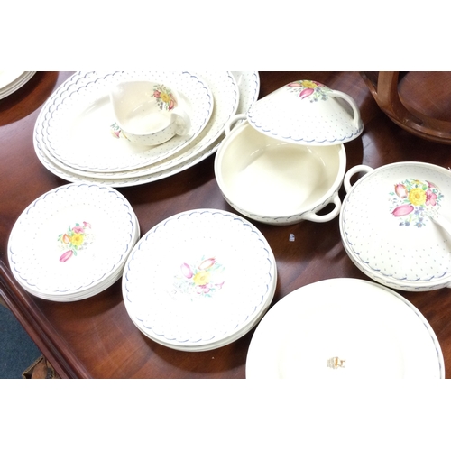 73 - An extensive Susie Cooper dinner service of typical form. Est. £80 - £120.