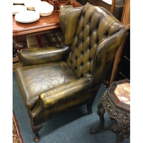 79 - A good leather button back smokers chair. Est. £40 - £60.