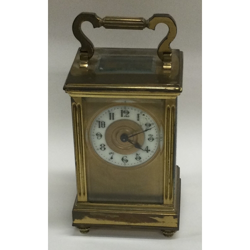 8 - A small brass carriage clock together with an MOP card case. Est. £20 - £30.