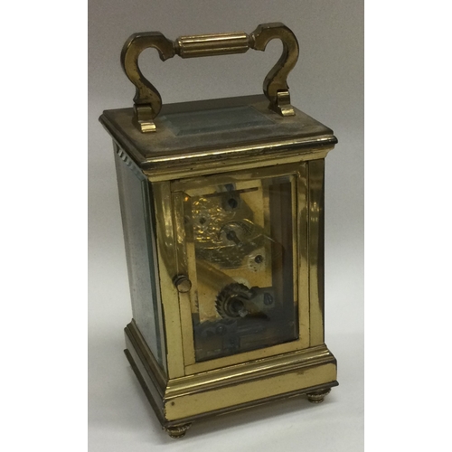 8 - A small brass carriage clock together with an MOP card case. Est. £20 - £30.