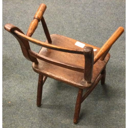 9 - An old child's stick back chair. Est. £20 - £30.