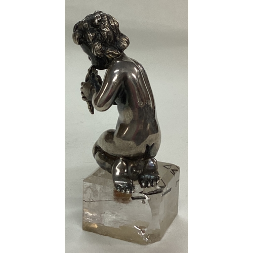 115 - A 19th Century novelty silver figure of musical cherub on square base. Approx. 129 grams of gross we... 