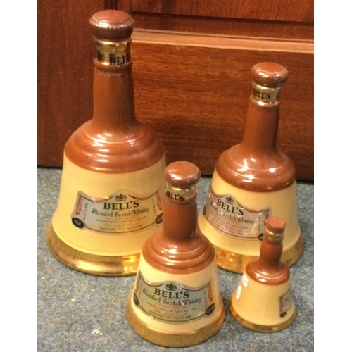 1262 - A set of four graduating sized bell shaped bottles of Bell's Blended Scotch Whisky. Est. £20 - £30.