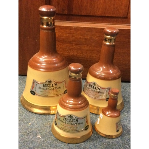 1262 - A set of four graduating sized bell shaped bottles of Bell's Blended Scotch Whisky. Est. £20 - £30.