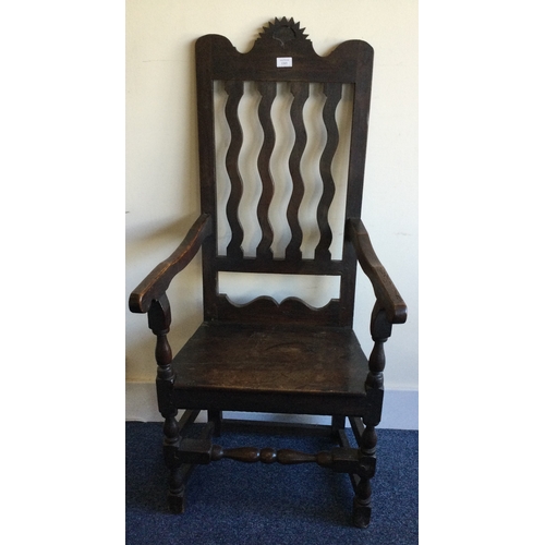 1301 - An Antique oak hall chair on turned supports. Est. £30 - £50.