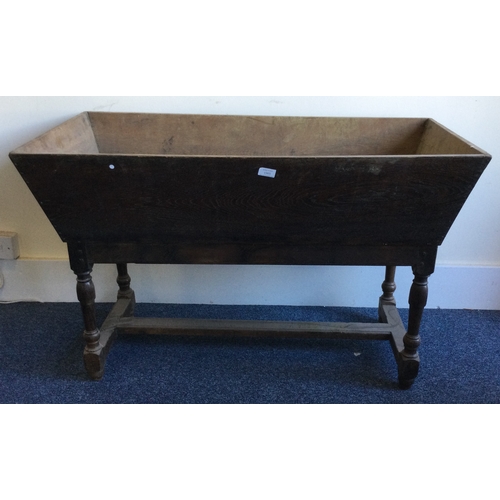 1305 - A large tapering oak dough bin on tapering supports. Est. £50 - £80.