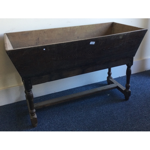 1305 - A large tapering oak dough bin on tapering supports. Est. £50 - £80.