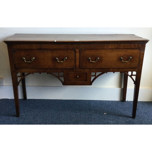 1311 - A good early oak three drawer sideboard with brass handles. Est. £150 - £200.