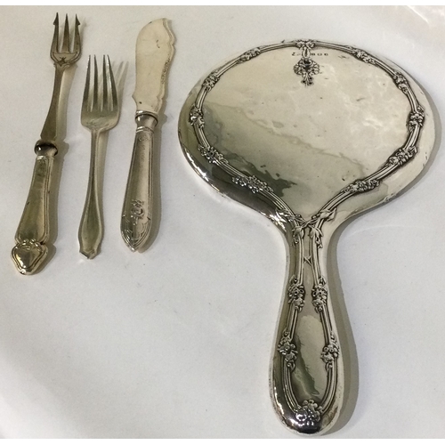 154 - A silver mounted dressing table mirror together with a butter knife etc. Est. £15 - £20.