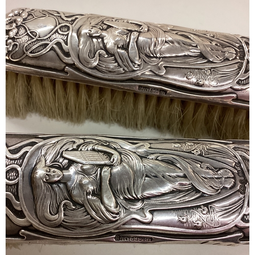 170 - A novelty silver clothes brush chased with women. Birmingham 1904. By William Aitkin. Est. £40 - £60... 