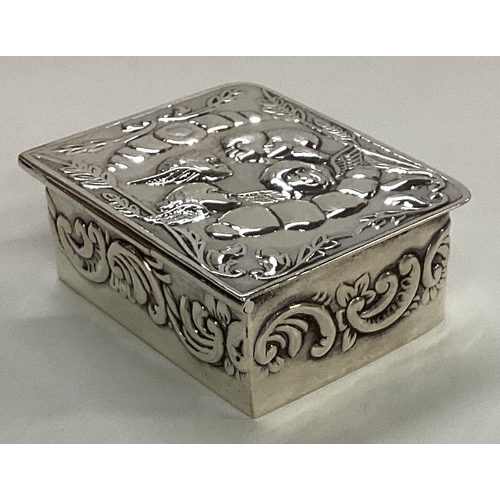 193 - A novelty silver hinged box in the form of a book with chased with cherubs and angels. Marked to bas... 