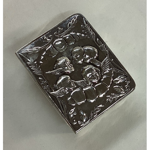 193 - A novelty silver hinged box in the form of a book with chased with cherubs and angels. Marked to bas... 