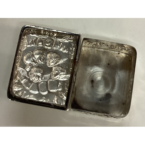 193 - A novelty silver hinged box in the form of a book with chased with cherubs and angels. Marked to bas... 