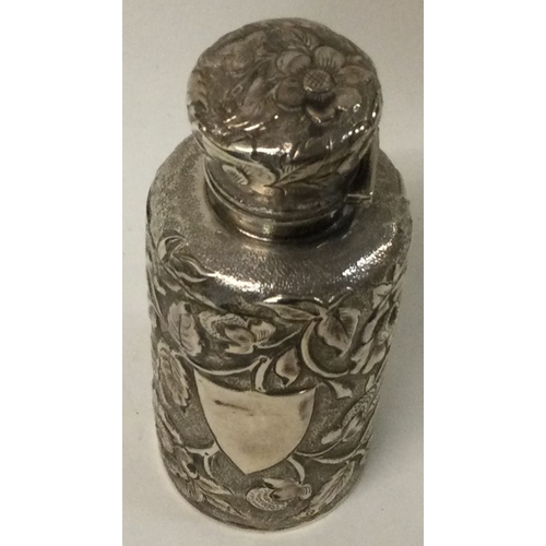 225 - A Victorian chased silver scent bottle with glass stopper embossed with flowers. Birmingham 1869. Ap... 