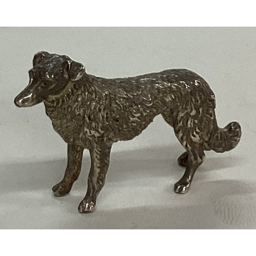 26 - A silver figure of a dog. Approx. 30 grams. Est. £30 - £50.