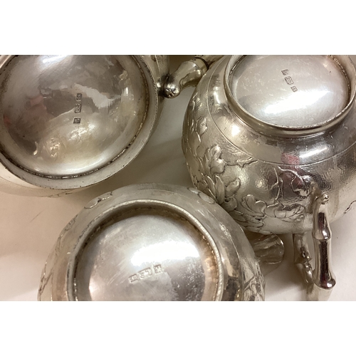 286 - A Chinese export silver three piece tea service. Circa 1900. Marked to base. By LS. Approx. 784 gram... 