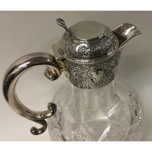 293 - A Victorian silver and glass claret jug. London 1898. By Goldsmiths and Silversmiths. Est. £300 - £5... 