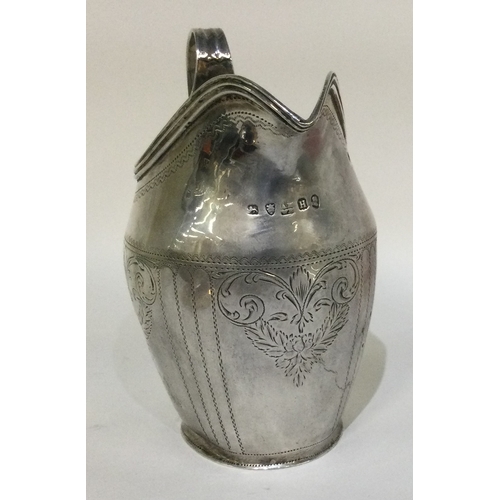 3 - A heavy Georgian silver cream jug with scroll decoration. Approx. 93 grams. Est. £50 - £80.