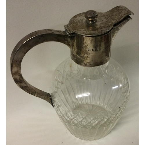 346 - A Edwardian silver and glass claret jug. Birmingham 1913. Est. £200 - £300.