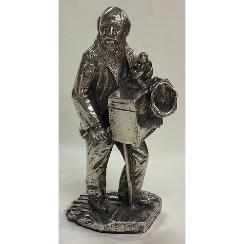 36 - A large silver plated figure of a man with monkey. Est. £20 - £30.