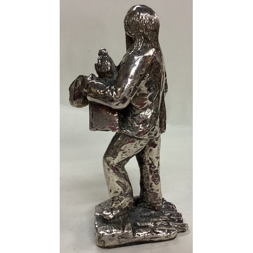 36 - A large silver plated figure of a man with monkey. Est. £20 - £30.