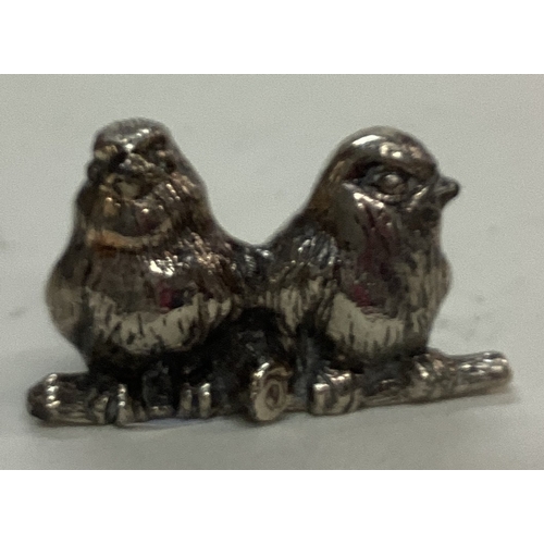 42 - A silver plated figure of birds. Est. £20 - £30.