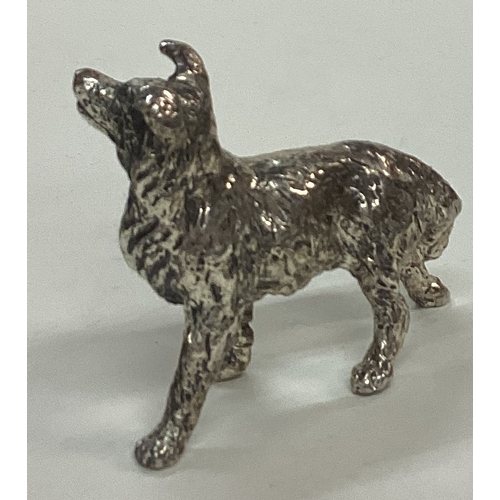 43 - A silver plated figure of an dog. Est. £20 - £30.