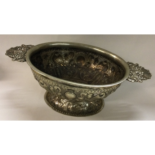 438 - An Antique 19th Century Dutch silver chased bowl with pierced handles. Marked to base. Appro. 345 gr... 