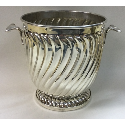 441 - A novelty silver two handled ice bucket of fluted design. Birmingham 1996. By Victoria Silverware Lt... 