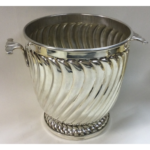 441 - A novelty silver two handled ice bucket of fluted design. Birmingham 1996. By Victoria Silverware Lt... 