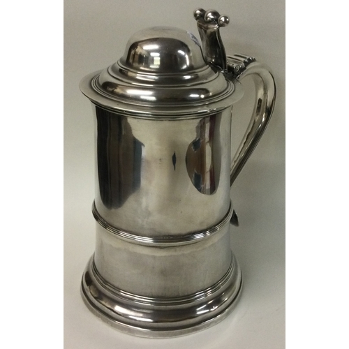 452 - A large heavy Georgian silver lidded tankard of tapering form. Marked to lid and base. Sheffield 180... 