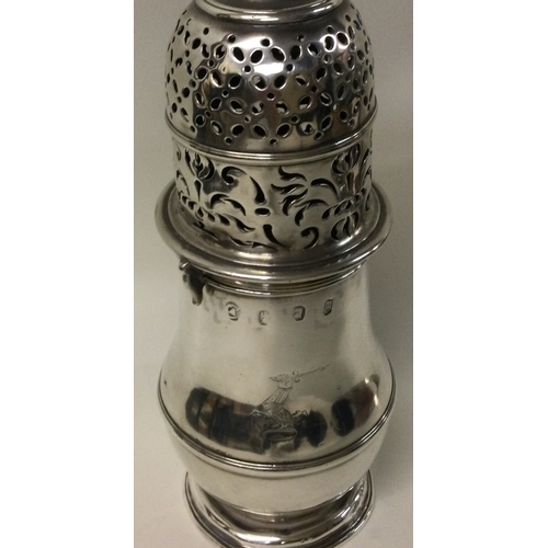 453 - A large Queen Anne silver bayonet top sugar caster of baluster form with crested side. London 1707. ... 