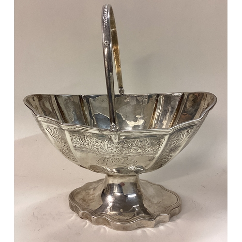 466 - EXETER: An engraved Victorian silver swing handled basket. 1879. By Josiah Williams and Co. Approx. ... 